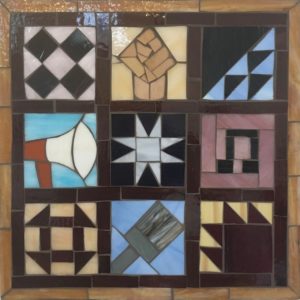 The Fight For Freedom Continues 2017: This piece uses the designs of quilt squares sewn and displayed to guide slaves along the Underground Railroad as a starting point, and builds on the idea of using crafts and everyday materials to make political change by adding updated imagery in the style of quilt squares.  Each of the squares tells an important story about creative resistance.